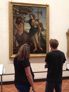 Students contemplating the Pallas and the Centaur, a painting by Sandro Botticelli, c. 1482, located at the Uffizi Gallery in the heart of Florence.